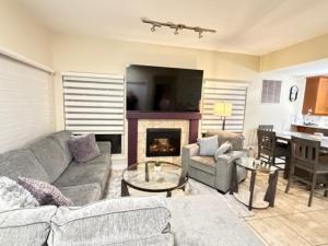 a living room with a couch and a fireplace at Lakeshore Villa Estates in Osoyoos