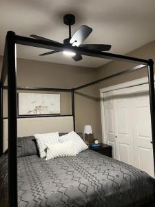 a bedroom with a bed with a ceiling fan at Lakeshore Villa Estates in Osoyoos +21 photos
