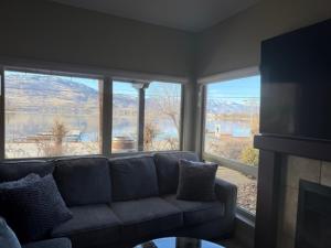 a living room with a couch and a large window at Lakeshore Villa Estates in Osoyoos