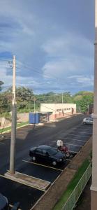 a black car parked on the side of a street at Apartamento Serenidade! in Uberaba