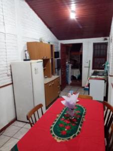 a kitchen with a table with a red table cloth at Isabella in Xuí