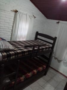a wooden bed in a room with a window at Isabella in Xuí