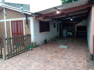 a garage with a red door and a fence at Isabella in Xuí