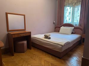 a small bedroom with a bed and a mirror at Restoran Gurman in Kraljevo