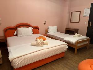 two beds in a hotel room with towels on them at Restoran Gurman in Kraljevo