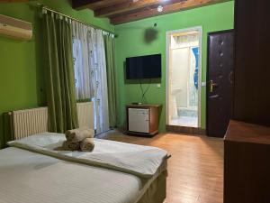 a bedroom with a bed with a teddy bear on it at Restoran Gurman in Kraljevo