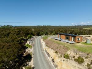 a house on a hill with a road at Estuary Escape in Kaingaroa