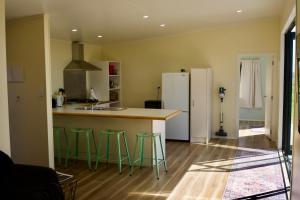 a kitchen with a counter and a refrigerator at Estuary Escape in Kaingaroa