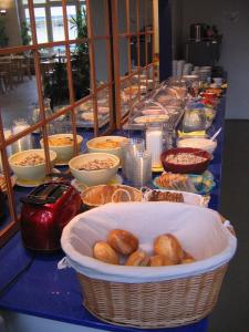 a buffet of food on a long blue table at Hotel Transit Loft in Berlin