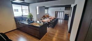 a kitchen and living room with a table and chairs at Yuki Lodge Myoko in Myoko