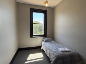 a bedroom with a bed and a window at Golden Age Hotel in Beaufort