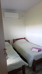 two beds sitting next to each other in a room at Cabañas El Calabrés in Tacuarembó +3 photos