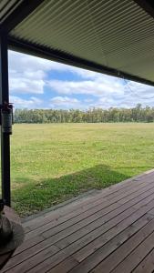 a view of a field from a screened in porch at Cabañas El Calabrés in Tacuarembó