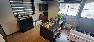 a small kitchen with a sink and a counter at Yuki Lodge Myoko in Myoko