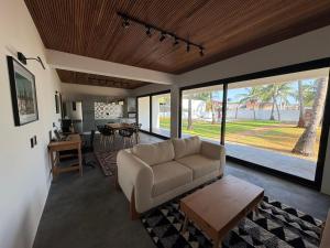 a living room with a couch and a table at Casa Olivia - Eureka in Atins