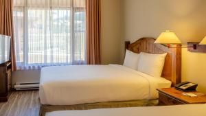 a hotel room with a bed and a window at Cahilty #120 home in Sun Peaks
