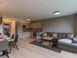 a living room with a couch and a table at Kitzbüheler Alpenlodge Top A2 in Mittersill +25 photos