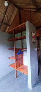 a wooden book shelf in a room at Alam Kita in Karimunjawa