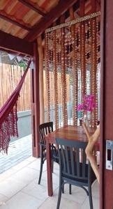 a wooden table and chairs on a patio at Villa do Sol Sagi in Baía Formosa