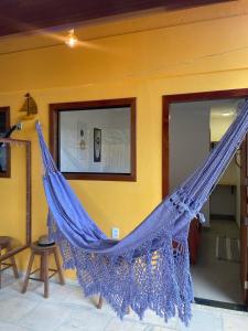 a hammock hanging on a wall in a room at Villa do Sol Sagi in Baía Formosa