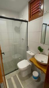 a bathroom with a toilet and a sink and a shower at Villa do Sol Sagi in Baía Formosa +16 photos