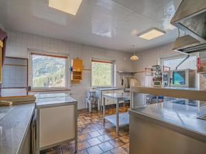 a large kitchen with tables and a window at Falkenstein in Krimml +26 photos