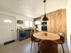 a kitchen with a table and chairs in a room at Alma de Areia - Alma Nossa in Montijo