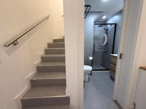 a bathroom with stairs and a toilet and a shower at Alma de Areia - Alma Nossa in Montijo +14 photos
