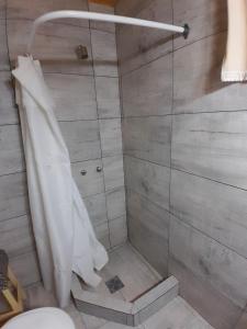a bathroom with a shower with a shower curtain at La Pradera in Tres Picos