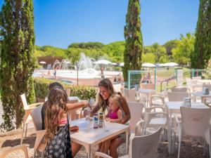 two girls sitting at a table at a restaurant at great mobile home in Cesenatico in Cesenatico