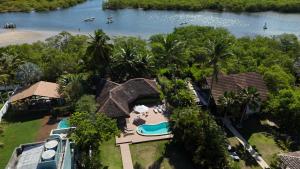 an aerial view of a house with a swimming pool at Amélia Pousada de Charme in Porto De Galinhas