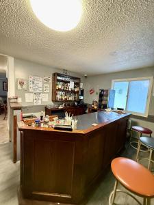 a kitchen with a bar with two stools and a counter at Melville Country Inn in Melville