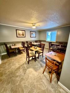 a dining room with wooden tables and chairs at Melville Country Inn in Melville