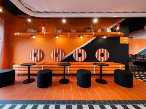 a room with a couch and some chairs and mirrors at ibis Styles La Rochelle Centre les Minimes in La Rochelle
