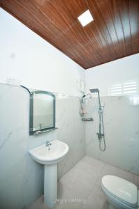 a bathroom with a sink and a toilet and a mirror at Eden Udawalawe in Udawalawe +69 photos