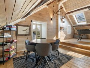 a dining room with a table and chairs and a piano at Mansion in Aywaille with sauna in Aywaille