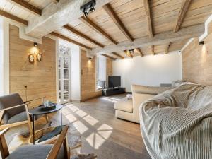 a living room with a couch and a table at Mansion in Aywaille with sauna in Aywaille