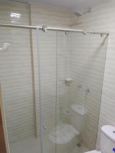 a glass shower with a toilet in a bathroom at Hospedaje Santa Barbara in Tabio