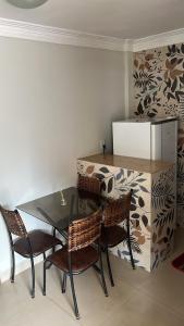 a kitchen with a table and chairs and a refrigerator at Pousada 705 Norte 2 in Brasília