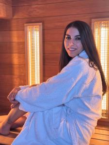 a woman is wrapped in a blanket at City-Top Panorama House & Apartments in Esztergom +45 photos