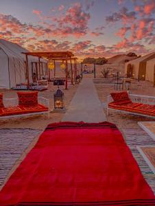 a red carpet on a path in the desert at Merzouga heritage camp in Merzouga +31 photos