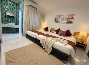 a hotel room with two beds in a room at Villa Santoni Mũi Né in Mui Ne +11 photos