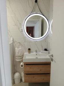 a bathroom with a sink and a mirror on the wall at Apartment Zavalatica 184a in Čara