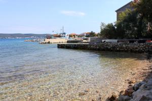 a beach with a boat in the water at Apartment Nevidjane 8401a in Neviđane +20 photos
