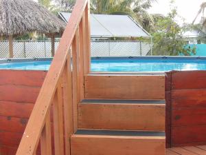 a wooden stairway leading to a swimming pool at LAKE VIEW CONDO in Belize City +23 photos