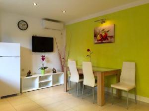 a dining room with a table and white chairs at Apartment Zavalatica 184c in Čara