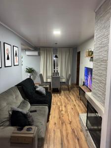 a living room with a couch and a table at House in Santa Vitória Do Palmar in Santa Vitória do Palmar