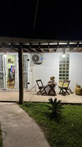 a patio with two chairs and a table on a patio at House in Santa Vitória Do Palmar in Santa Vitória do Palmar