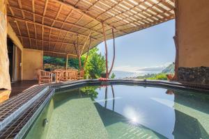 an infinity pool in a villa with a view at Vanira Lodge in Teahupoo