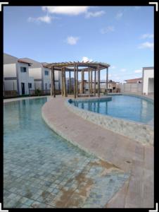 a large swimming pool with a pavilion in the middle at Maramarbh43 in Luis Correia